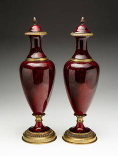 PAIR OF PAUL MILET (FRENCH, 1870-1950) FOR SEVRES ORMOLU-MOUNTED PORCELAIN URNS.: Paul Milet (French, 1870-1950) for Sevres, Early 20th Century. Two beautiful mottled red flambe-glazed porcelain vases with gilt bronze mounts and hardware. Marked "MP / SEVRES" and stamped "MADE IN F