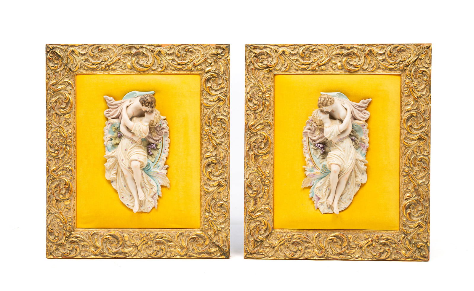 PAIR OF EUROPEAN CAPODIMONTE STYLE "LOVERS EMBRACE" BISQUE WALL PLAQUES.: European, 20th Century. Giltwood rectangular frames, plush velour fields, each with a man and a woman in an embrace. 21.5"h. 18.5"w.