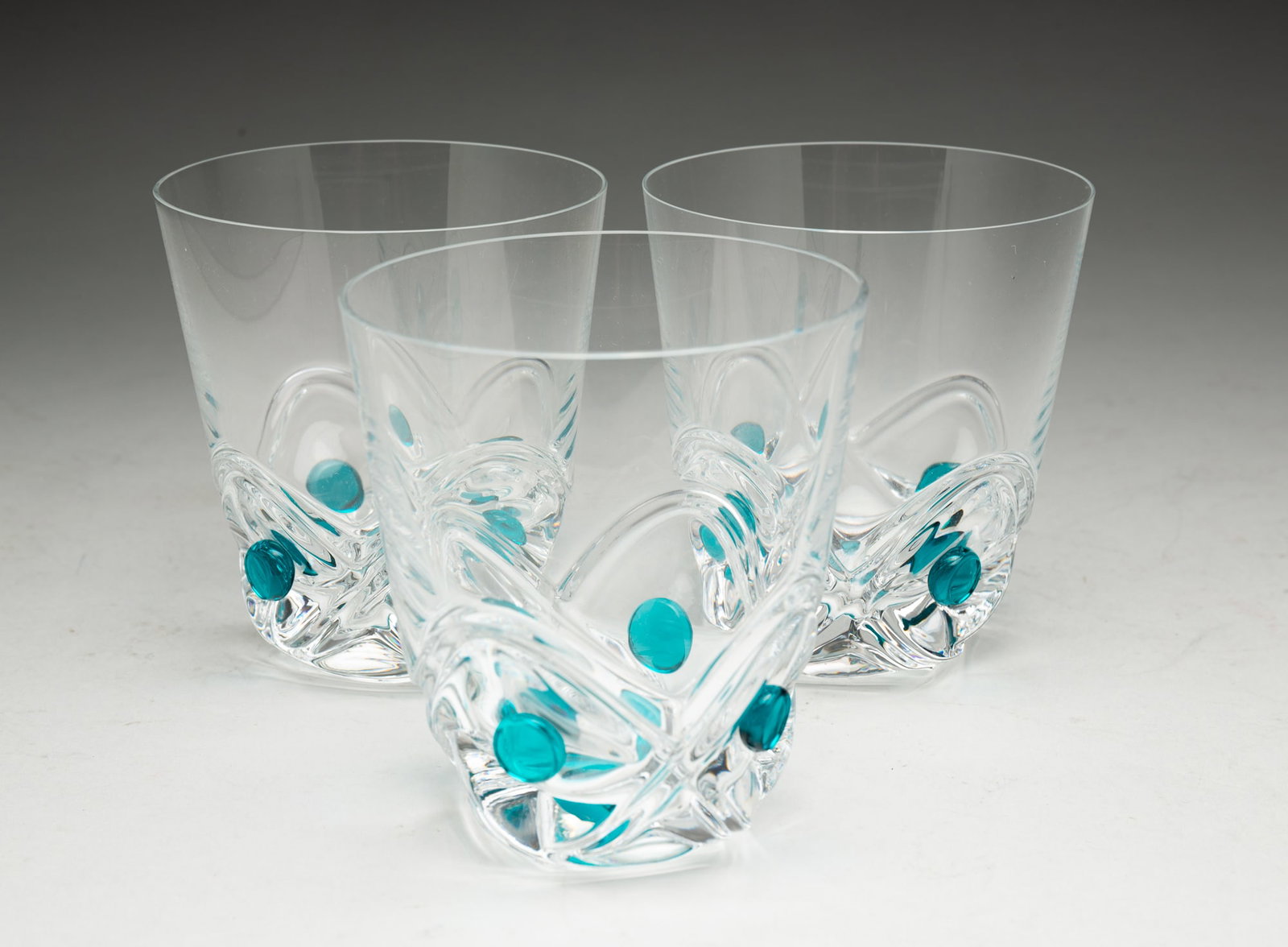 THREE LALIQUE "FLORIDE" CRYSTAL TUMBLERS.: France, 20th Century. Large fifteen ounce tumblers with patterned bases, aqua blue dots and signed on underside, 4.25"h. 4"d.