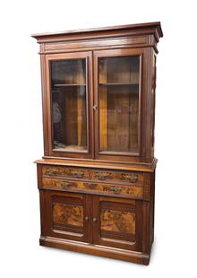 VICTORIAN WALNUT AND BURL WALNUT BOOKCASE.: American, Late 19th Century. Walnut, burled veneer and poplar secondary. In two pieces that did not start out life together. Top with cove molded cornice, paneled ends, two single pane glass doors and
