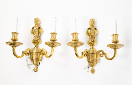 PAIR OF AMERICAN BRASS CUPID BUST TWO-ARM WALL SCONCES.