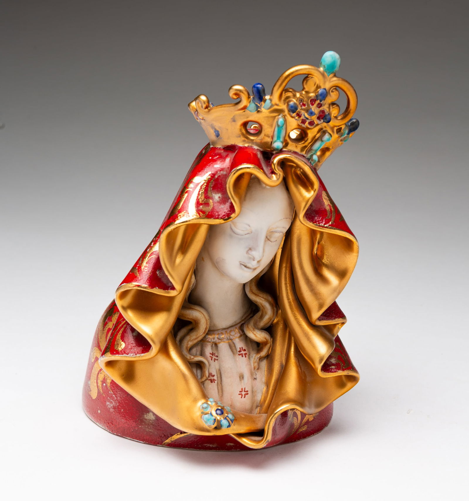 IN THE STYLE OF EUGENIO PATTARINO (ITALIAN, 1885-1971) BUST OF MADONNA.: Italian, Mid-20th Century. Earthenware. Hand painted diminutive bust of Madonna wearing a red and gold cloak and a crown. Signed "Perami" who was a student of Pattarino. 7.75"h. 5.25"w.