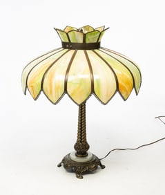 TABLE LAMP WITH PANELED GREEN SLAG GLASS SHADE.