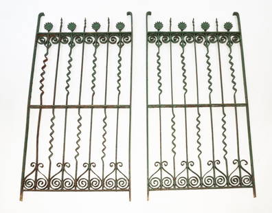 PAIR OF AMERICAN GREEN-PAINTED WROUGHT IRON GARDEN GATES.: American, ca. 1900. Having scrolls and flower motifs. Each, 63"h. 32"w. Provenance: Michael Seward Rutland Antiques (Vermont). From the collection of Mark and Sandy Keily.