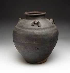 ASIAN BLACK GLAZED EARTHENWARE JAR.