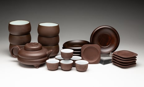 GROUP OF TWENTY-FOUR CHINESE YIXING POTTERY TEA ACCESSORIES.