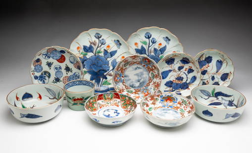 GROUP OF ELEVEN JAPANESE IMARI PORCELAIN BOWLS AND PLATES.: Japan, 19th and 20th Centuries. Two bowls with foliate form rims; the centers decorated with a scene of water, a boat, mountains, and trees in blue; surrounded by polychrome and gilt phoenix, dragon,