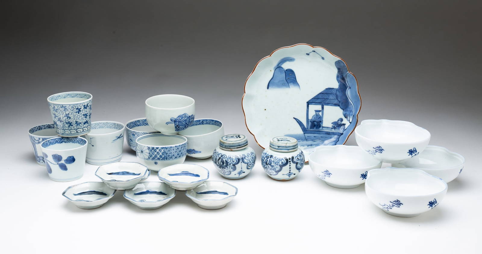 GROUP OF TWENTY-TWO CHINESE AND JAPANESE BLUE AND WHITE PORCELAIN DISHES.