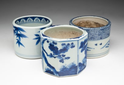THREE JAPANESE BLUE AND WHITE PORCELAIN BRUSH POTS.