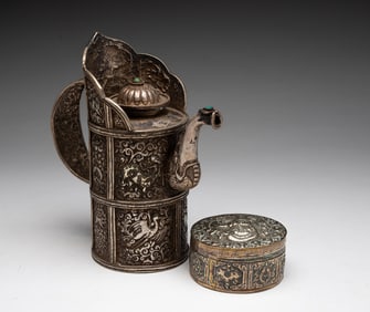 HIMALAYAN HAND CHASED WHITE METAL TEAPOT AND BETEL BOX.
