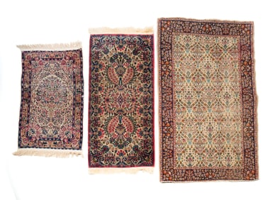 THREE FLORAL HAND KNOTTED RUGS.