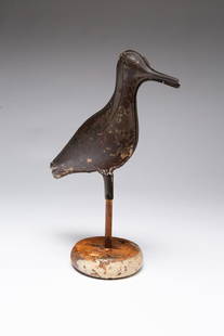 AMERICAN PAINTED TIN SHOREBIRD DECOY WITH PINE STAND.: American, ca. 1900. Die-pressed in two sections with worn black and white paint. On a pine round white-painted stand. 11.5"h.