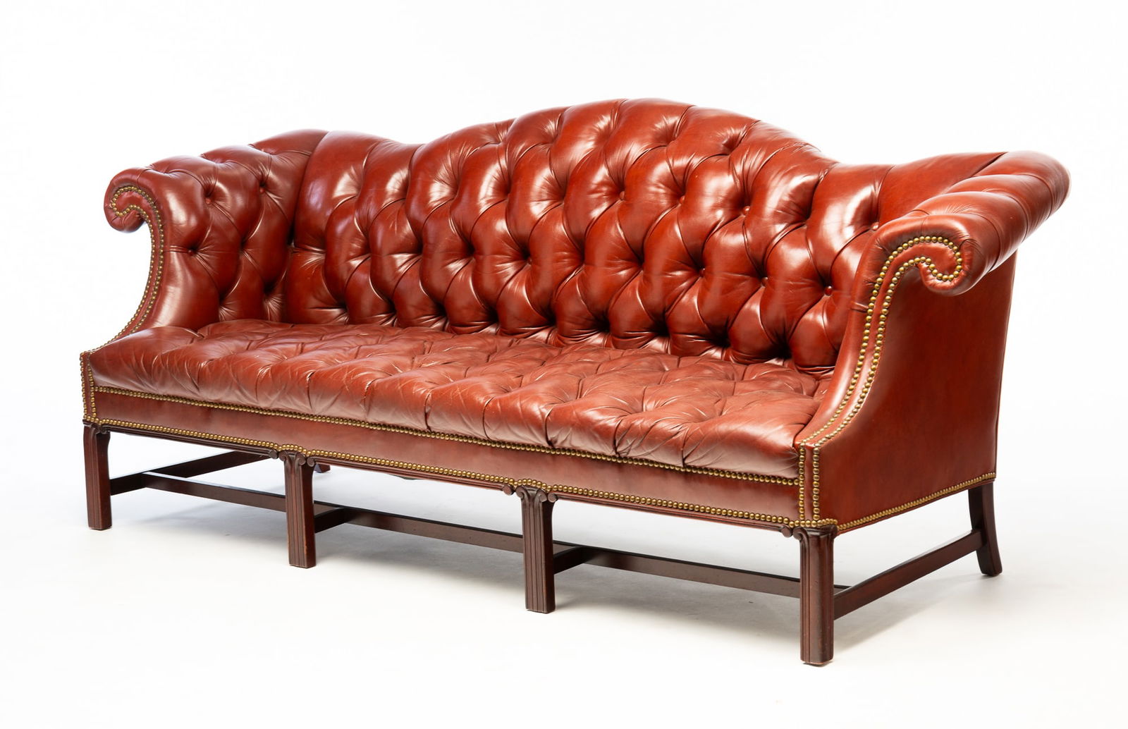 CHIPPENDALE STYLE BUTTONED-DOWN LEATHER CAMELBACK SOFA WITH BRASS TACKS. (1 of 4)