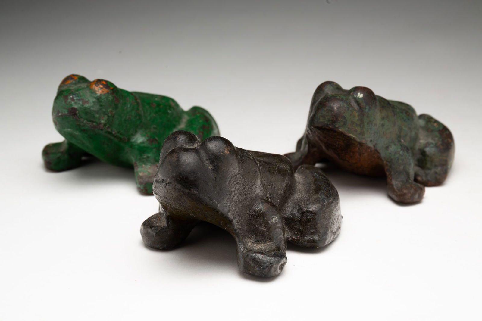 THREE CAST IRON FROG DOORSTOPS. (1 of 3)