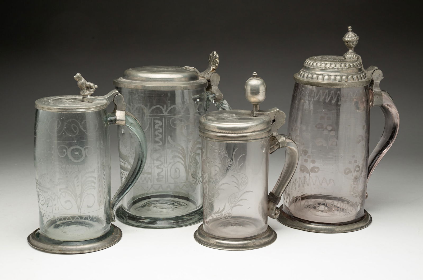 FOUR GERMAN BLOWN AND ETCHED GLASS BEER STEINS. (1 of 6)