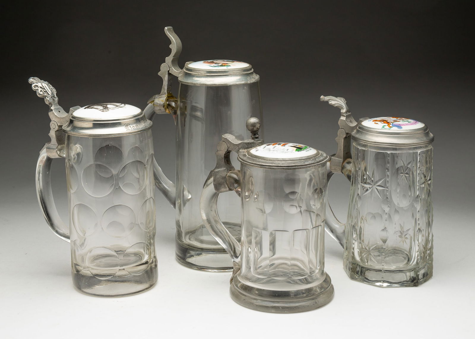 FOUR GERMAN GLASS BEER STEINS. (1 of 8)
