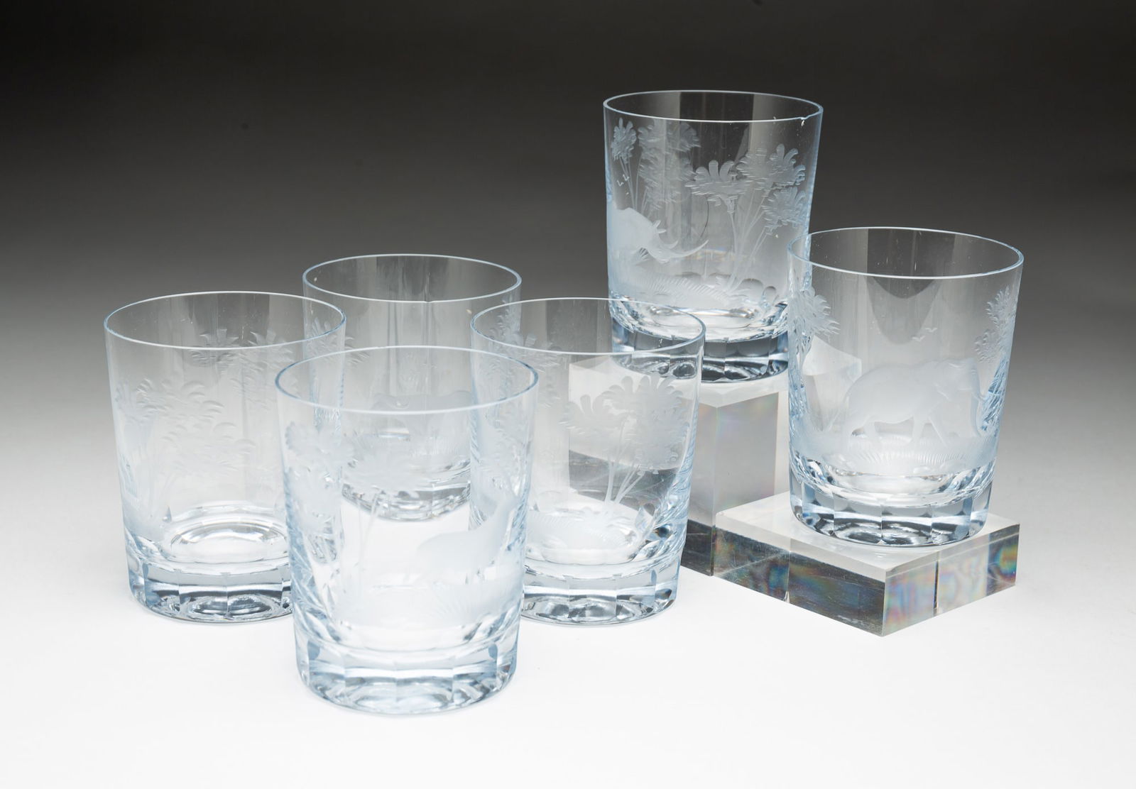 SIX QUEEN LACE "KENYAN WILDLIFE" ENGRAVED CRYSTAL OLD FASHIONED GLASSES.: Germany, 20th Century. Comprising an elephant, lion, Cape buffalo, giraffe, rhinoceros, and antelope. Each, 4"h. 3.25"d.