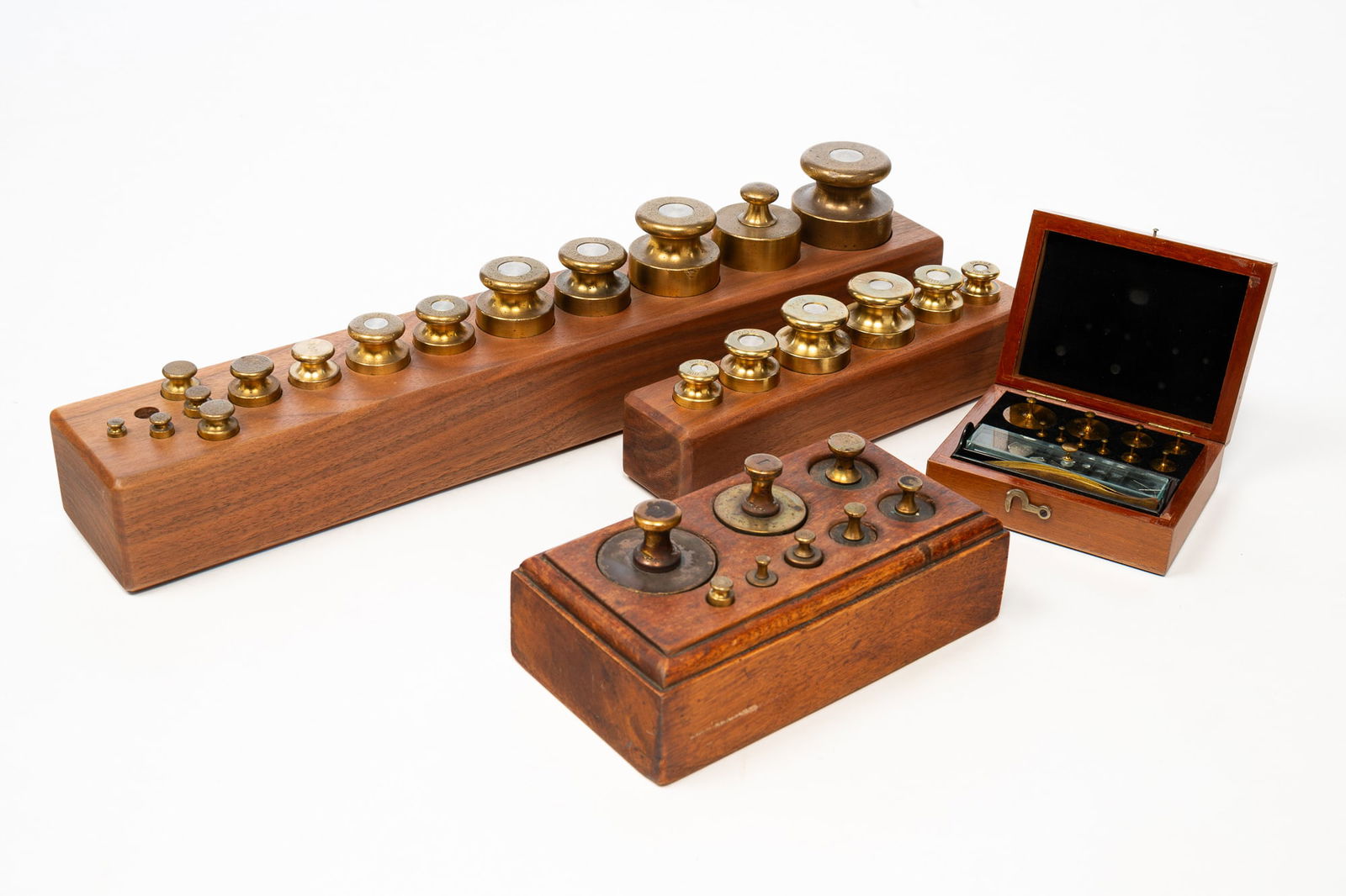 FOUR SETS OF BRASS SCALE WEIGHTS. (1 of 6)