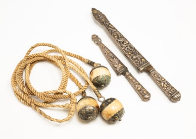 ARGENTINIAN BONE AND SILVER GAUCHO BOLAS AND TWO GAUCHO DAGGERS WITH SILVER HANDLES AND SHEATHS.