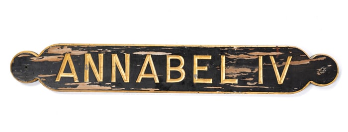 "ANNABEL IV" EBONIZED, PARCEL-GILT, AND RELIEF-CARVED SHIP'S STERNBOARD.