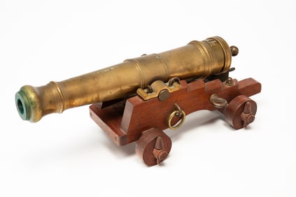 NAUTICAL SIGNAL CANNON ON MAHOGANY CARRIAGE.