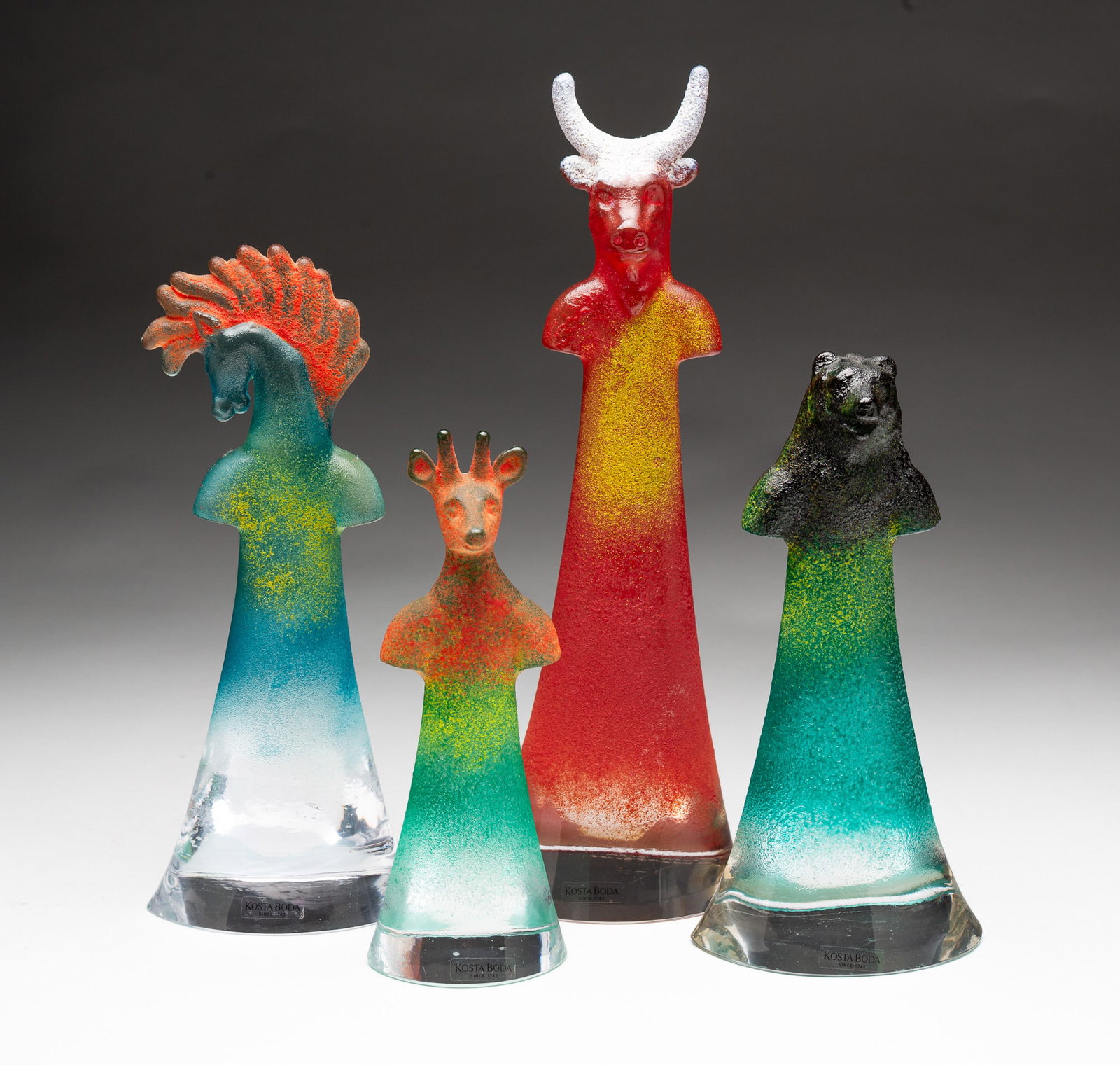 FOUR KJELL ENGMAN (SWEDISH, B. 1946) FOR KOSTA BODA "WELL SERIES" GLASS SCULPTURES.: Kjell Engman (Swedish, b. 1946) for Kosta Boda. Bull is model number 90134, 11.25"h.; horse is model number 90132, 9"h.; bear is model number 90132, 7.75"h.; and deer is model number 90131, 7"h.