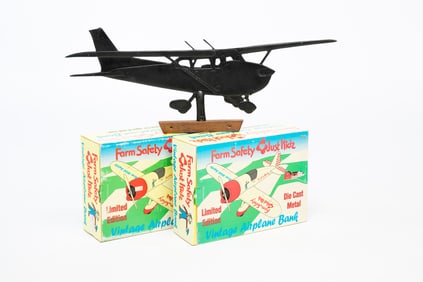 TWO BOXED METAL BANKS AND AN AIRPLANE WEATHERVANE.