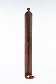 PAINTED TIN BILLIARD CUE CASE, BONE BILLIARD CUE, AND THREE BILLIARD BALLS ON CUSTOM WOOD STAND.