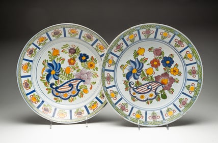 TWO DELFT FAIENCE SHALLOW BOWLS WITH POLYCHROME DECORATION.