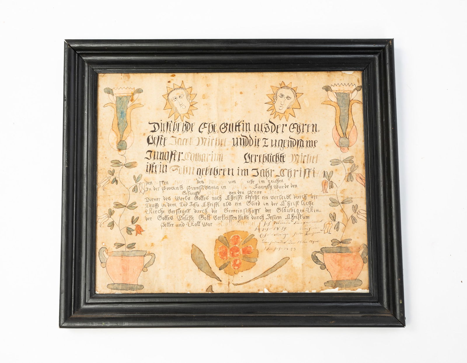 PENNSYLVANIA WATERCOLOR AND INK FRAKTUR.: American (Pennsylvania), Early 19th Century. Watercolor and ink on paper. Text to center with decorative border comprised of faces, urns, and flowers. In a painted wood frame behind glass, 17"h. 19.75