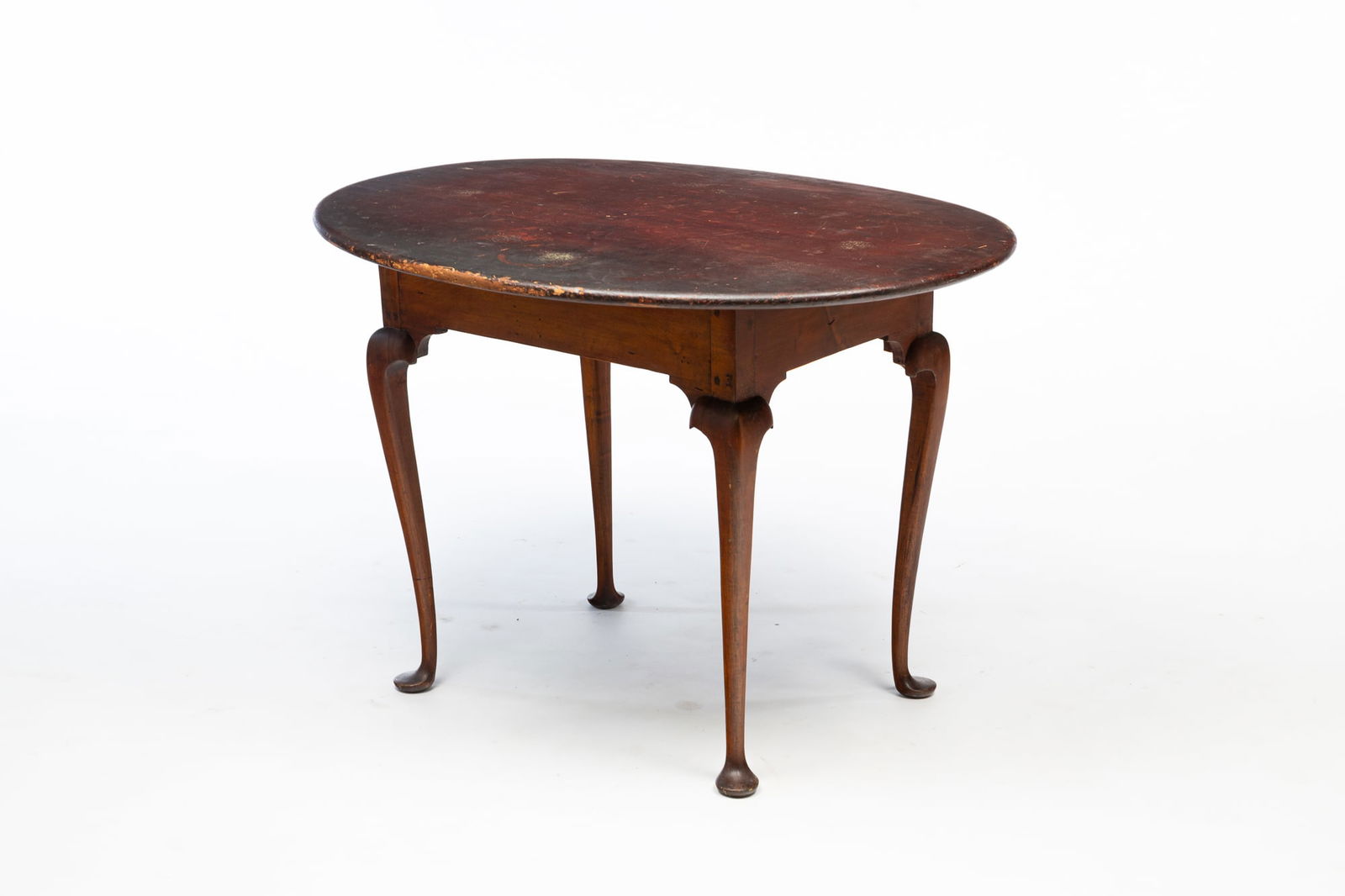 AMERICAN QUEEN ANNE PINE TEA TABLE.: American, Mid 18th Century. Pine. Oval top with rounded edge, plain apron, cabriole legs with pad feet, and pegged construction. Older finish. 26.5"h. 38"w. 28.5"d.Provenance: From the Lifetime Collec