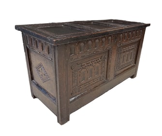 ENGLISH EBONIZED AND CARVED OAK COFFER.