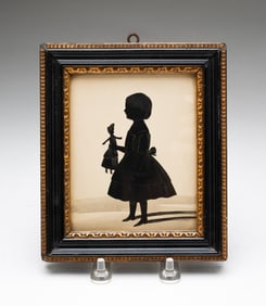 ENGLISH SCHOOL CUT PAPER FULL-LENGTH PROFILE SILHOUETTE OF A GIRL HOLDING A QUEEN ANNE DOLL.