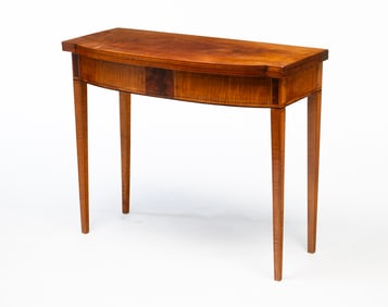 AMERICAN HEPPLEWHITE MAHOGANY, BIRCH, AND TIGER MAPLE BOWFRONT CARD TABLE.
