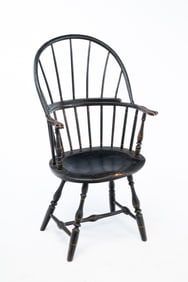 AMERICAN EBONIZED AND YELLOW-PINSTRIPED SACKBACK WINDSOR ARMCHAIR.