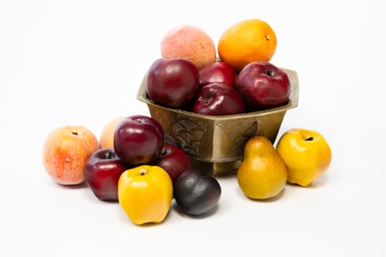 BRASS BOWL FILLED WITH MOLDED FRUIT.