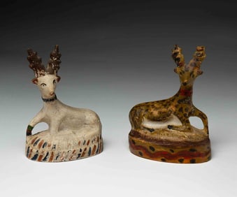 TWO PENNSYLVANIA CHALKWARE RECUMBENT STAGS.