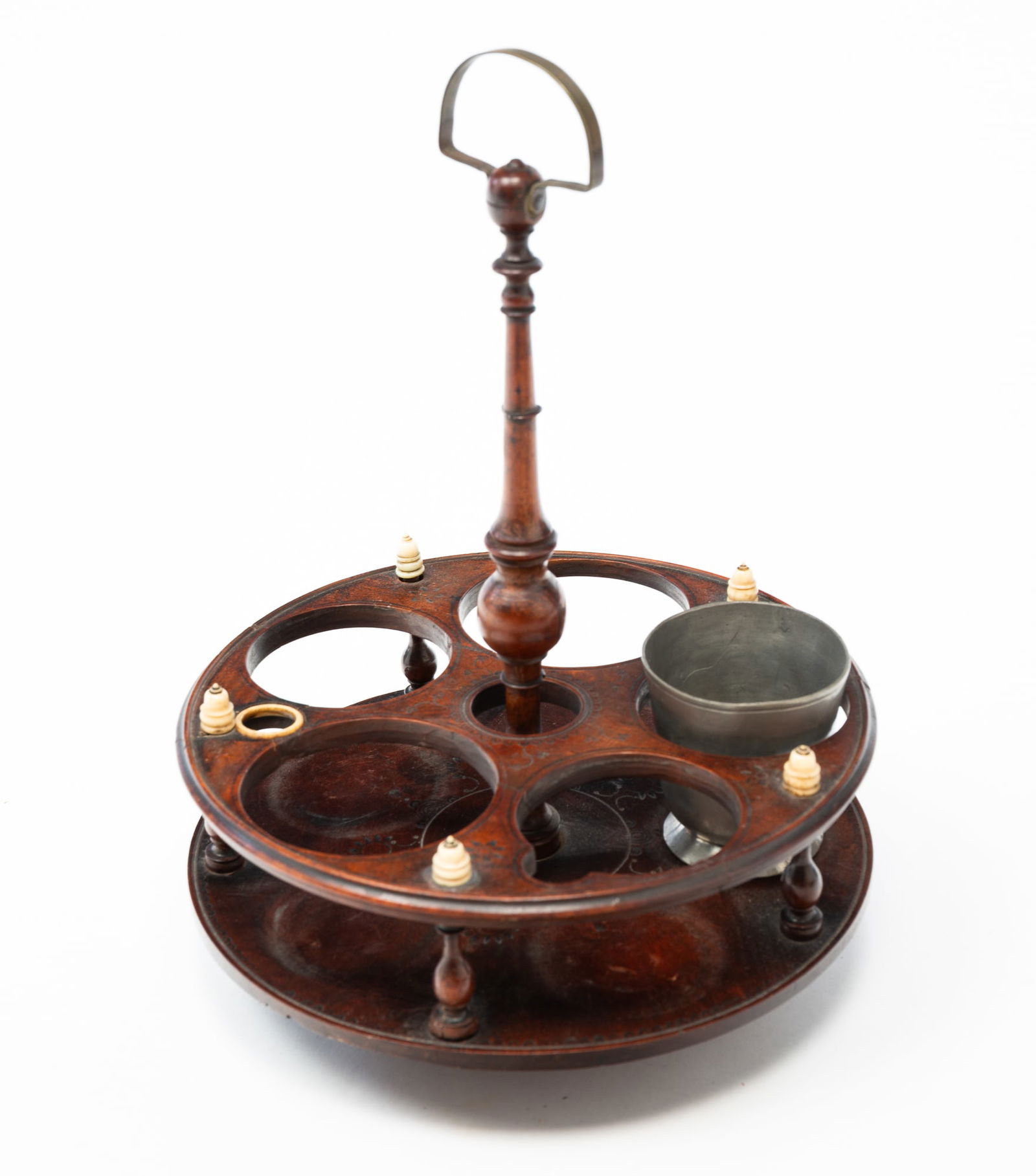 WALNUT AND WHALEBONE CRUET STAND.: American, 19th Century. Finely turned center column, frame supports, and whale bone finials. Frame with intricate incised and die stamped decoration. Brass bale handle. 11.5"h. Included is a footed pe