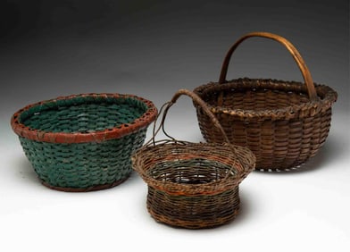 THREE AMERICAN WOVEN BASKETS, INCLUDING A RED AND TEAL-PAINTED EXAMPLE.