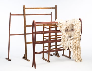 THREE AMERICAN SLATTED WOOD QUILT RACKS AND A BED TESTER FRAME WITH COVER.
