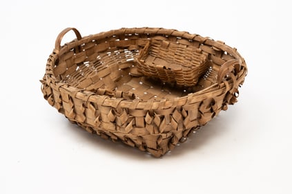 UNUSUAL NATIVE AMERICAN HANDLED SEWING BASKET WITH CURL ACCENTS.