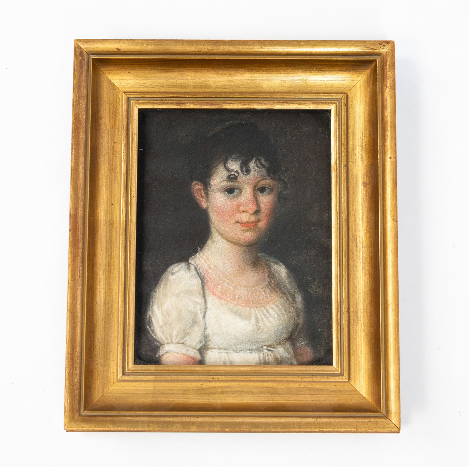 EUROPEAN SCHOOL PASTEL PORTRAIT OF A YOUNG LADY.: European, Early 19th Century. Pastel on paper. Young girl dressed in a white dress with lace collar, she wears her dark hair pinned up with curls on her forehead and a ruddy complexion. Note to back i