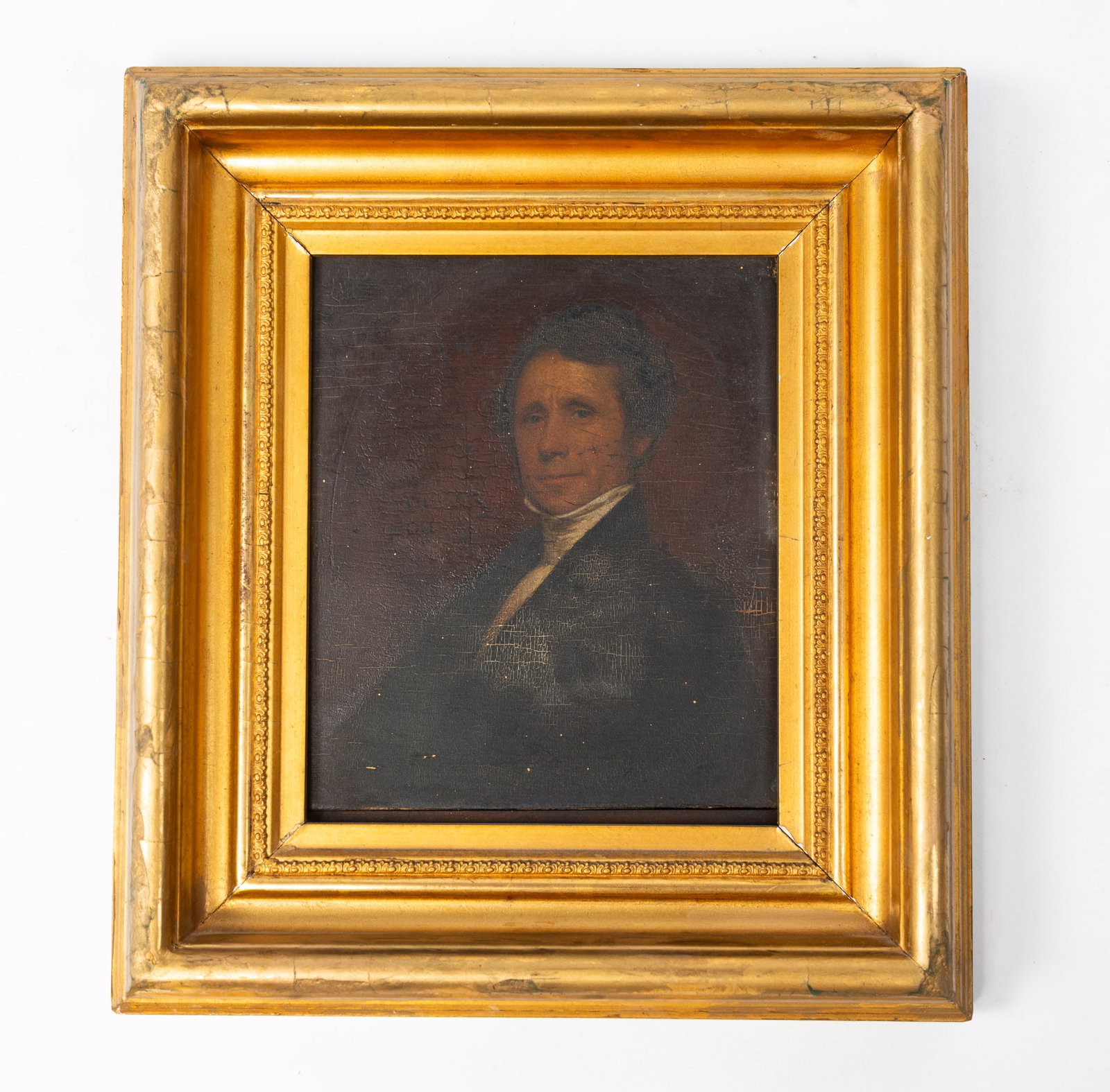AMERICAN SCHOOL DIMINUTIVE OIL ON BOARD PORTRAIT OF A GENTLEMAN.: American, 19th Century. Oil on wooden board. Unsigned. Seated gentleman with a high white collared shirt and black coat with a smirk on his face. Illegible writing to the left of his face. Partial Bro
