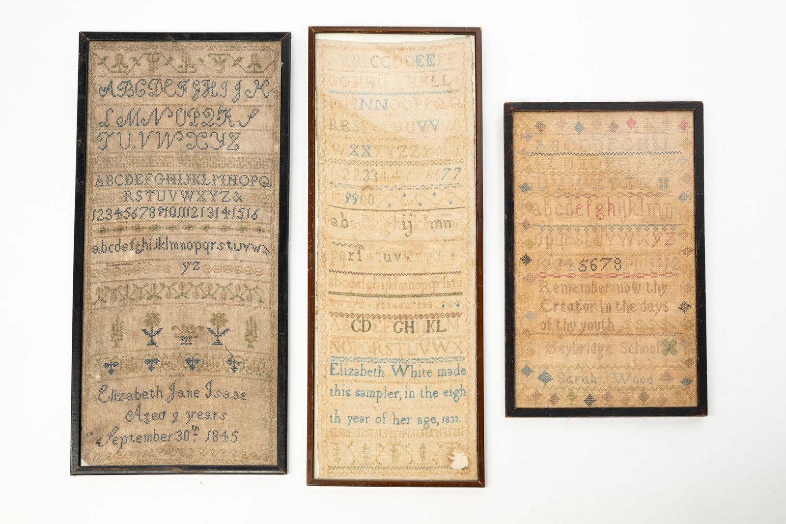 THREE NEEDLEPOINT SAMPLERS.: American, 19th Century. In wood frames behind glass. Alphabet and numerals, religious verse, signed "Meybridge School", "Sarah Wood" and with a diamond border. 16.75"h. 10.5"w. Alphabets, numerals, fl