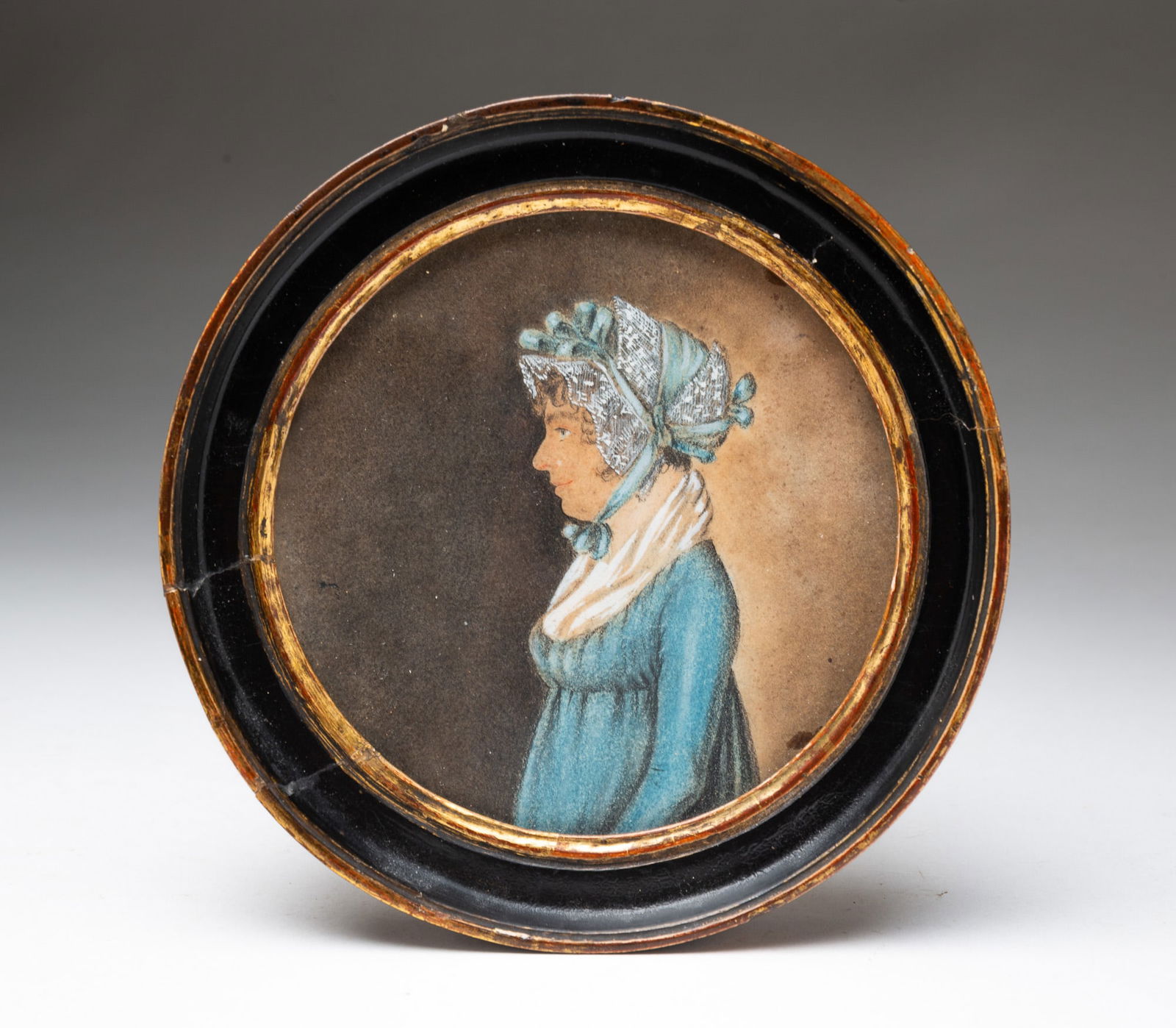 AMERICAN SCHOOL MINIATURE CHARCOAL AND GOUACHE PROFILE PORTRAIT OF A WOMAN. (1 of 3)