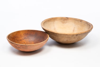 TWO LARGE AMERICAN TURNED PINE AND MAPLE BOWLS.