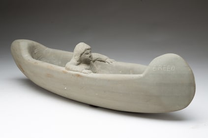 ERNEST "POPEYE" REED (OHIO, 1919-1985) FOLK ART DIMINUTIVE CARVED STONE NATIVE AMERICAN IN A CANOE,