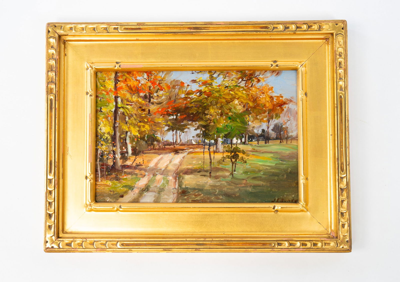 JOHN ELWOOD BUNDY (AMERICAN, 1853-1933) OIL ON BOARD OF WOODED LANDSCAPE.: John Elwood Bundy (American, 1853-1933). Oil on board. An impressionistic depiction of a wooded landscape with winding path. Signed to lower right. Sight, 6"h. 8.75"w. Framed, 9.75"h. 12.75"w.Provenan