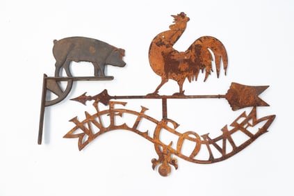 A CAST IRON PIG BRACKET AND IRON ROOSTER WELCOME SIGN.