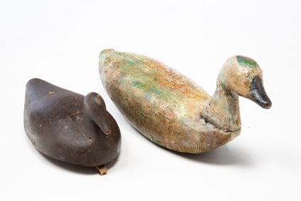 TWO PRIMITIVE CARVED AND PAINTED DUCK DECOYS.
